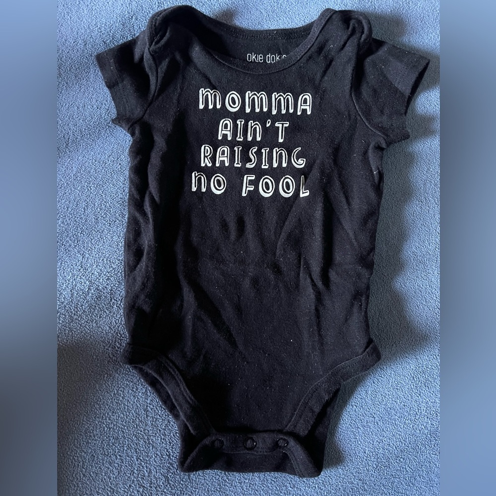 Black and white, short sleeve bodysuit. Mama ain’t raising no fool. Graphic Tee